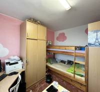A room in a 3-room apartment with a built-in wardrobe, a bunk bed, and a desk.