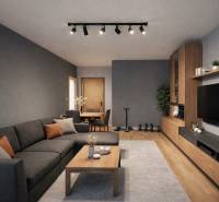 Living room in a 3-room apartment with a dark couch and a wooden decor floor.