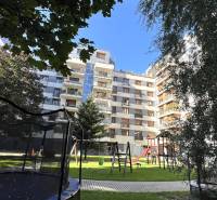 Apartment building on Drieňová Street in Bratislava - Ružinov with greenery and a children's playground.