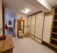 A hallway with storage cabinets and wooden decor in a 2-room apartment.