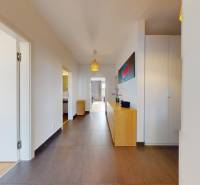 A bright hallway in a 3-room apartment with tiles and light furniture.