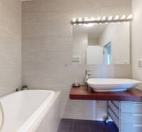 A bathroom in a 3-room apartment with a bathtub and designer tiles.