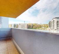 A balcony of a 3-room apartment with a view of the surrounding architecture on Staré Grunty in Bratislava.