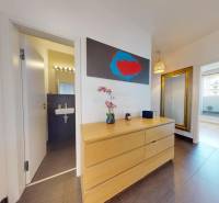 Interior of a 3-room apartment with wood decor flooring, a mirror, and wall decoration.