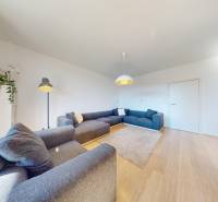 Living room in a three-room apartment with sofas and a wooden decor floor.