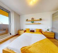 A bedroom in a 3-room apartment with wooden decor and direct access to the balcony.
