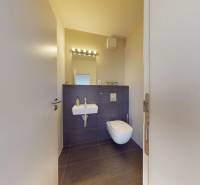 A bathroom in a 3-room apartment with a wall-hung toilet and a sink.