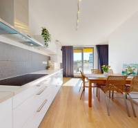 Kitchen and dining room with wood-patterned flooring in a 3-room apartment.