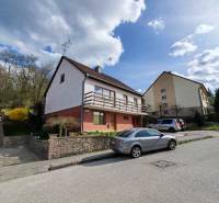 A family house on Závršky Street in Myjava with cars parked in front of it.