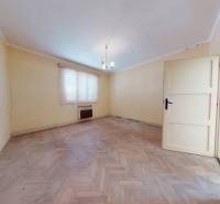 A bright room with a wood-decor floor in a family house.