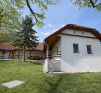 A family house in Podbranč with a garden and terrace, surrounded by nature and trees.