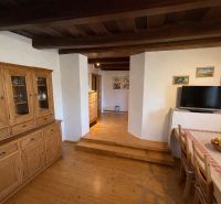 Interior of a family house with wooden furniture and a floor with a wood design.