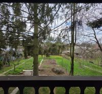 A view of a green plot in Bohdanovce surrounded by trees for living.