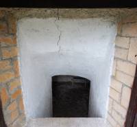 Entrance to a basement space with plastered walls and a brick frame, Land - residential.
