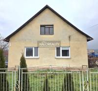 A family house in Čereňany with a simple facade and a front garden behind a fence.