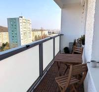 The balcony of a 3-room apartment on Púpavova Street in Bratislava - Karlova Ves with a wooden floor decor.