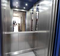 Interior of an elevator with lighting and metal walls in a 2-room apartment.