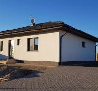 A family house on Jelšová Street in Bernolákovo with a white-gray facade and a yard.