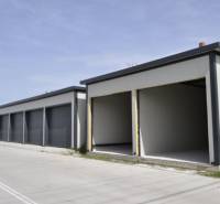 Garages in Michal na Ostrove with gray facades and open gates.