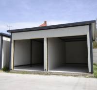 Garages in Michal na Ostrove with gray walls and empty interiors.