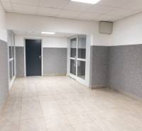 A hallway with tiles and white ceiling panels in a 4-room apartment.