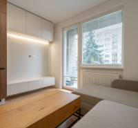 Living room in a 3-room apartment with a wooden decor floor, sofa, and furniture.
