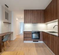 A kitchen in a 3-room apartment with wooden decor and stylish lighting.
