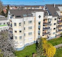 Apartment building on E. Belluša Street in Piešťany with blooming trees, suitable for a 3-room apartment.