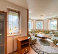 A living room with light furniture and a wood-decor floor in a 3-room apartment.