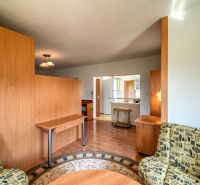 Living room with a sofa and wooden decor flooring in a 3-room apartment.