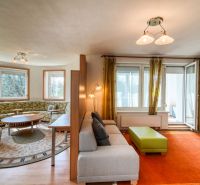 Living room in a 3-room apartment with a comfortable sofa and a wooden decor floor.