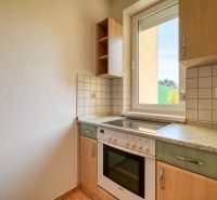 A kitchen in a 3-room apartment with ceramic tiles and an electric stove.