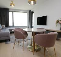 Living room in a two-room apartment with a wooden decor floor and stylish furniture.