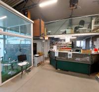 Commercial spaces with a glass wall and a workspace, floor with wood decor.