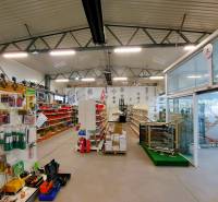 Retail spaces containing shelves with goods, racks, and stands with corporate advertisements.