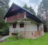A cottage in Borský Svätý Jur surrounded by greenery and forest, with a balcony and a garden.