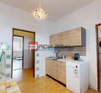 A kitchen in a family house with a wooden decor floor and a kitchen unit.