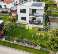 A family house in Martin with a landscaped garden, a gazebo, and solar panels on the roof.