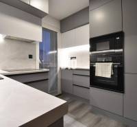 Kitchen in a 4-room apartment with built-in appliances and a wooden decor floor.