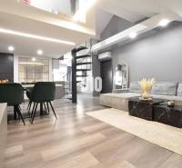 Elegant living space in a 4-room apartment with wood-patterned flooring and a spiral staircase.