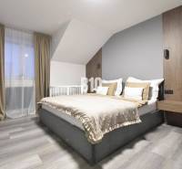 Bright bedroom with a comfortable bed in a 4-room apartment, floor with wood decor.