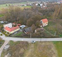 An aerial view of residential plots in Moravské Lieskové with buildings and greenery.