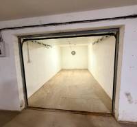 Empty garages with concrete floors and simple lighting.