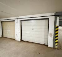 Garages with white doors on Nová Ves street in the town of Dunajská Streda.