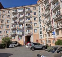 A five-story apartment building on ČSA Street, Košice - Staré Mesto district with a parking lot.