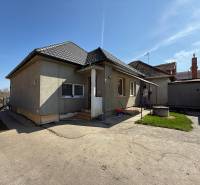 Family house in Zlaté Moravce with an unfinished facade, entrance area, yard with green lawn.