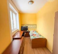 Bathroom in a 3-room apartment with a corner bathtub and white tiles.