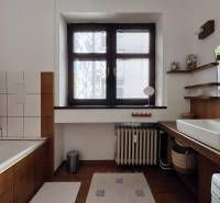 Bathroom with a shower and a sink, wooden decor flooring, 2-room apartment.