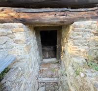 Stone entrance to the cellar under the cottage in Horná Mariková.