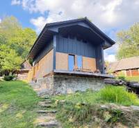 A cottage in the village of Horná Mariková with a stone foundation and surrounding nature.